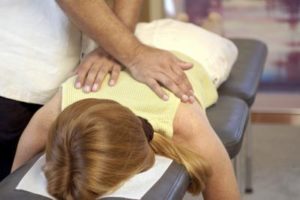 woman on chiro table w/ DC adjust